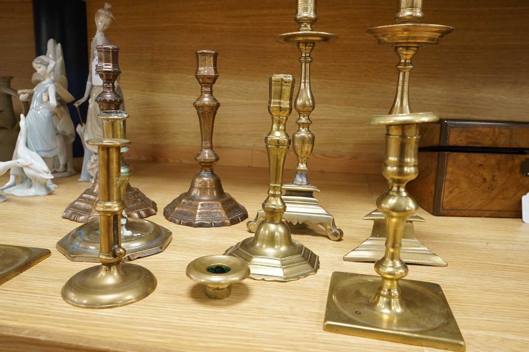 A group of period brass candlesticks, the majority 18th century